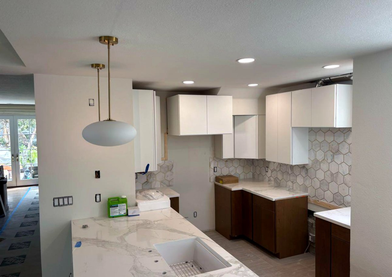 Modern kitchen with brass pendant lights
